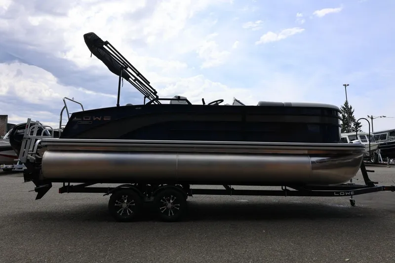 Slide: The Image of 2026 Lowe SS 210 CL pontoon boat on trailer under cloudy sky. - 10