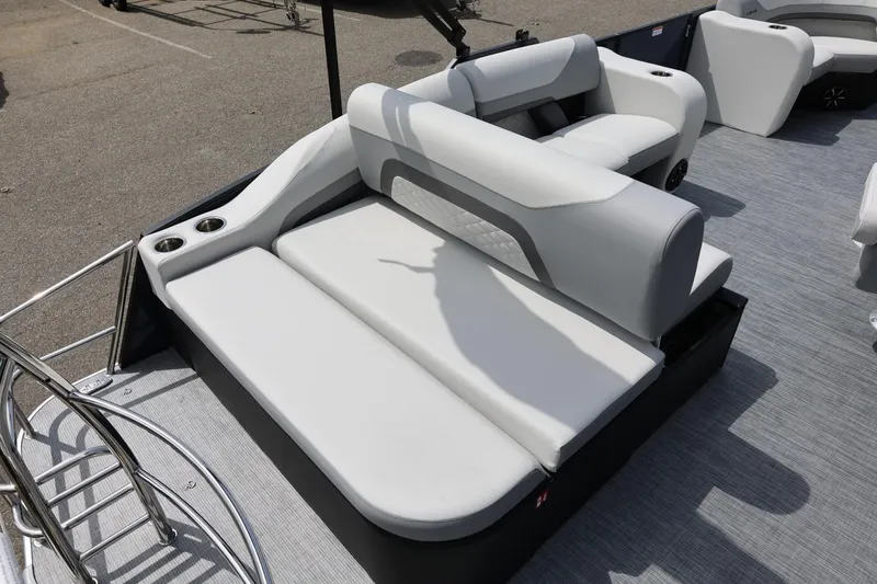 Slide: The Image of 2026 Lowe SS 210 CL pontoon boat interior with plush seating and cup holders. - 15