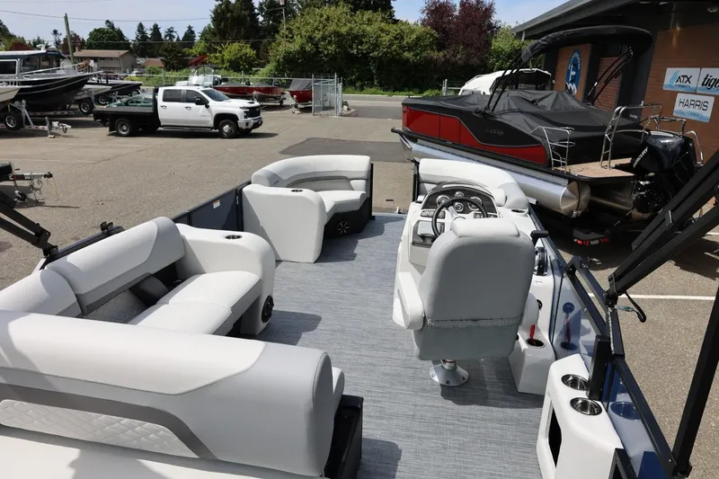 Slide: The Image of 2026 Lowe SS 210 CL pontoon boat interior with plush seating and modern helm. - 16