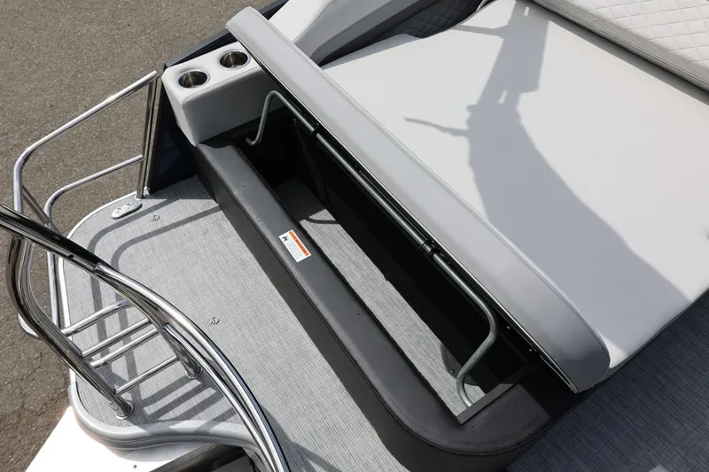 Slide: The Image of 2026 Lowe SS 210 CL boat with open storage compartment and cup holders. - 18