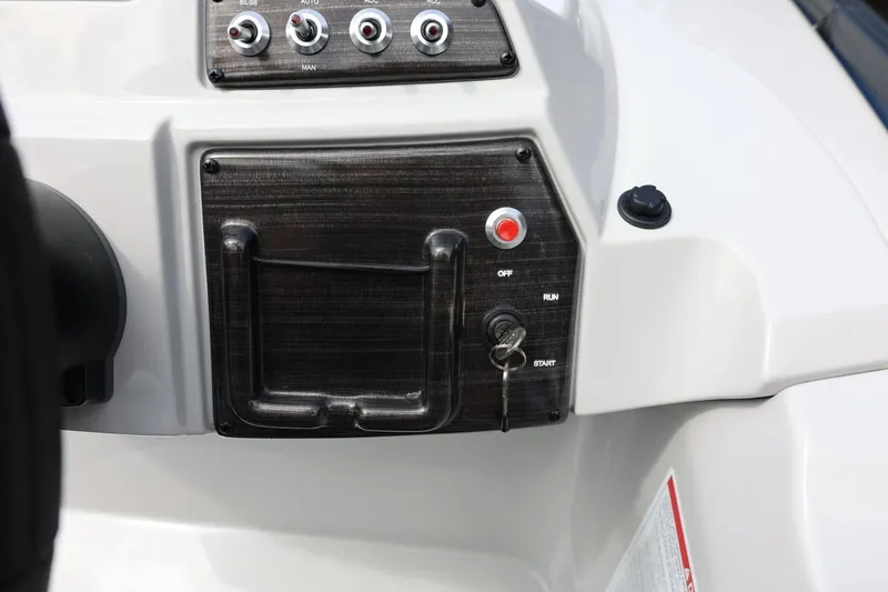 Slide: The Image of Control panel of 2026 Lowe SS 210 CL boat with switches and ignition key. - 29