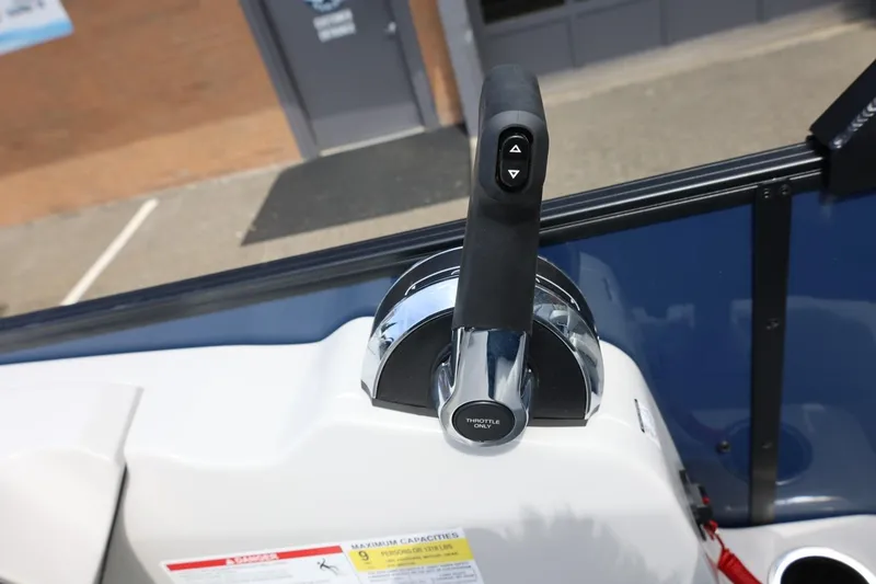 Slide: The Image of Throttle control lever on a 2026 Lowe SS 210 CL boat dashboard. - 31