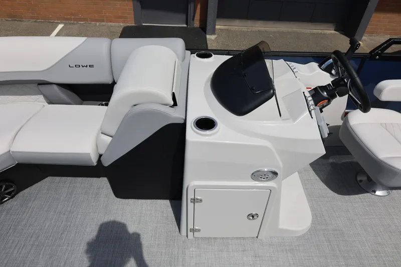Slide: The Image of 2026 Lowe SS 210 CL boat interior with steering console and seating. - 36
