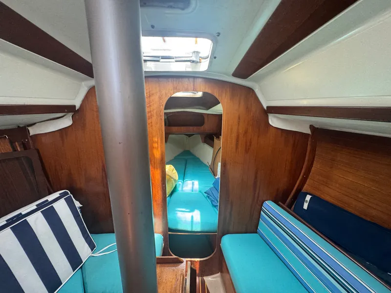 Slide: The Image of Interior of a 1988 Beneteau First 285 yacht with blue cushions. - 19