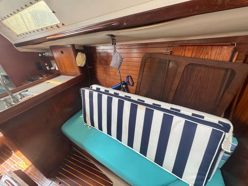 Slide: The Image of Interior of a 1988 Beneteau First 285 yacht with striped cushions. - 22