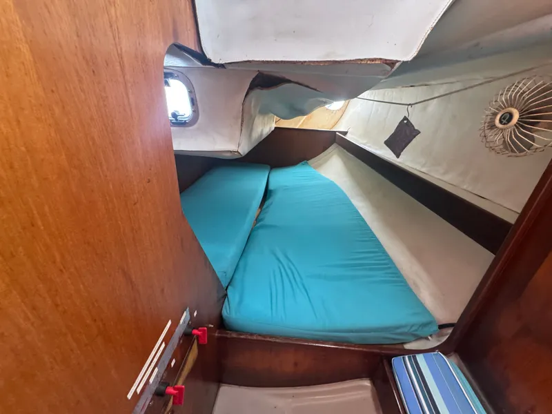 Slide: The Image of Interior of 1988 Beneteau First 285 yacht with blue cushions. - 23