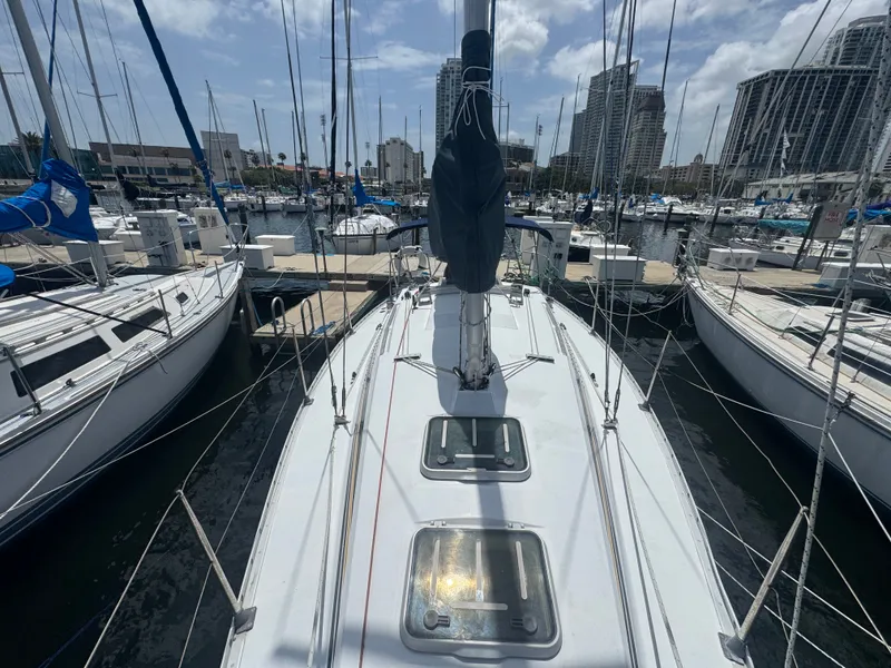 Slide: The Image of 1988 Beneteau First 285 sailboat docked in marina, surrounded by yachts. - 31