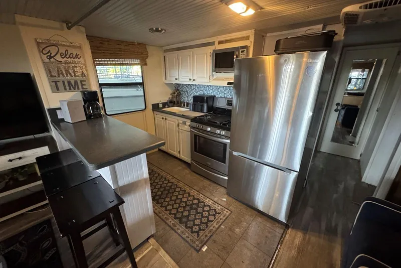 Slide: The Image of Interior of 2006 Catamaran Cruisers Aqua Cruiser Executive, featuring modern kitchen appliances. - 13