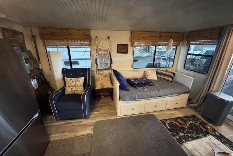 Slide: The Image of Interior of 2006 Catamaran Cruisers Aqua Cruiser Executive, featuring cozy seating and nautical decor. - 14