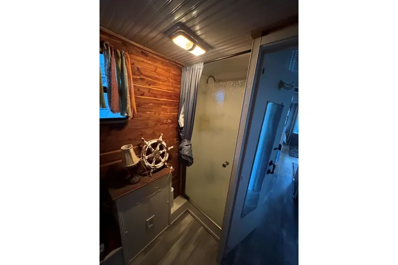 Slide: The Image of Bathroom interior of 2006 Catamaran Cruisers Aqua Cruiser Executive, featuring wood paneling and nautical decor. - 17