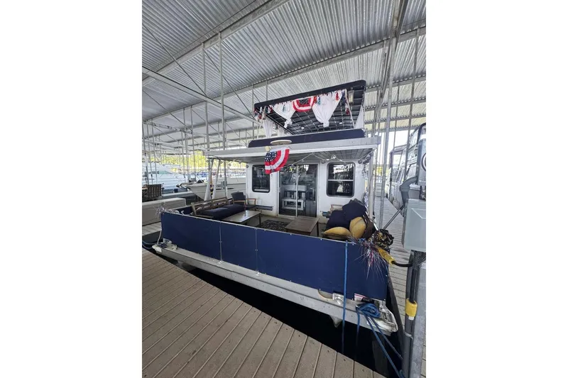Slide: The Image of 2006 Catamaran Cruisers Aqua Cruiser Executive 51' docked under a covered marina. - 2