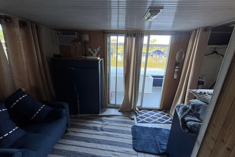 Slide: The Image of Interior of 2006 Catamaran Cruisers Aqua Cruiser Executive, featuring cozy seating and waterfront view. - 22