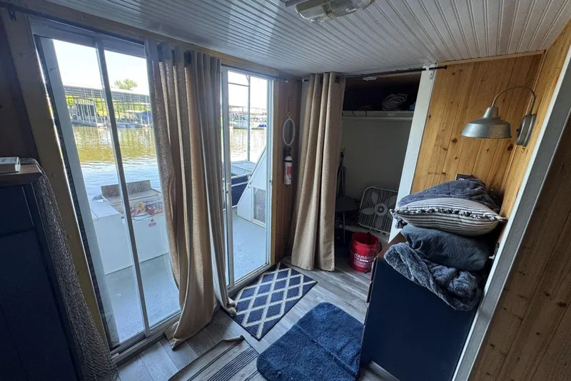 Slide: The Image of Interior of 2006 Catamaran Cruisers Aqua Cruiser Executive, featuring cozy cabin with lake view. - 23