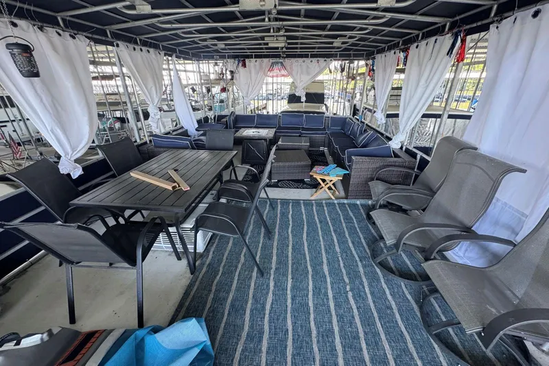 Slide: The Image of Spacious deck of 2006 Catamaran Cruisers Aqua Cruiser Executive with seating and dining area. - 24