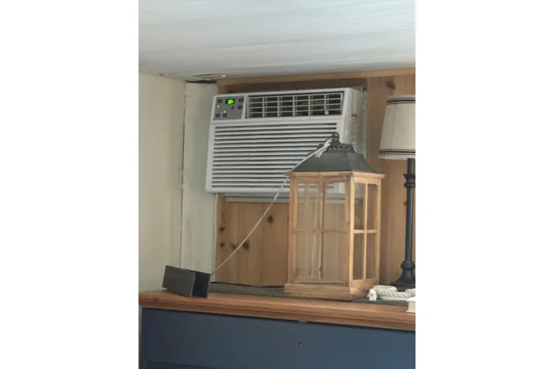 Slide: The Image of Wall-mounted air conditioner in 2006 Catamaran Cruisers Aqua Cruiser Executive, with wooden lantern decor. - 28