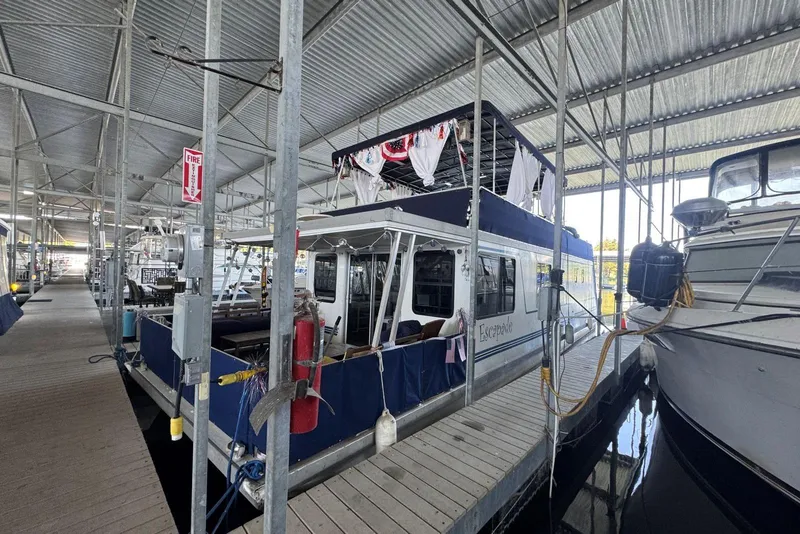 Slide: The Image of 2006 Catamaran Cruisers Aqua Cruiser Executive 51' docked in a covered marina. - 3
