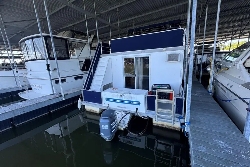 Slide: The Image of 2006 Catamaran Cruisers Aqua Cruiser Executive 51' docked in a marina, rear view. - 5