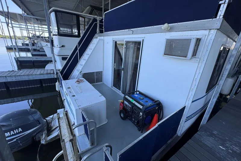 Slide: The Image of 2006 Catamaran Cruisers Aqua Cruiser Executive 51' docked, featuring outdoor equipment and Yamaha motor. - 6