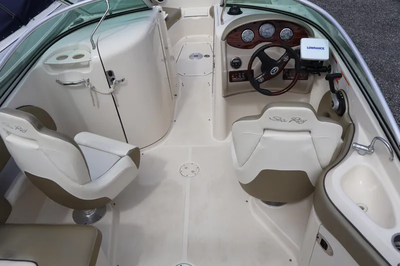 Slide: The Image of 2007 Sea Ray 220 Sundeck interior with helm, seating, and dashboard controls. - 12