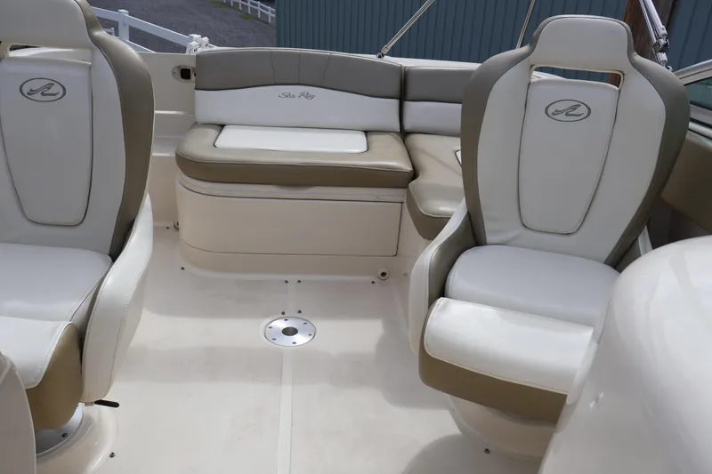 Slide: The Image of 2007 Sea Ray 220 Sundeck interior with beige and white seating, showcasing luxury boat design. - 13