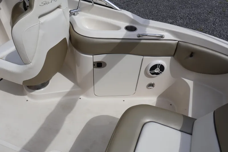Slide: The Image of Interior of a 2007 Sea Ray 220 Sundeck boat, featuring seating and storage. - 16