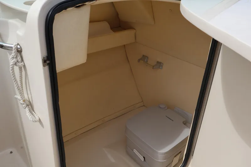Slide: The Image of 2007 Sea Ray 220 Sundeck interior with portable toilet and storage space. - 20