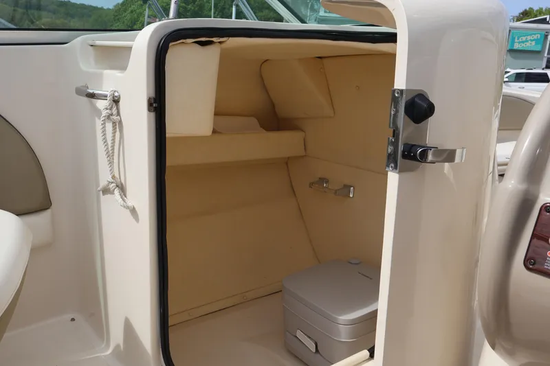 Slide: The Image of 2007 Sea Ray 220 Sundeck interior storage compartment with portable toilet. - 21