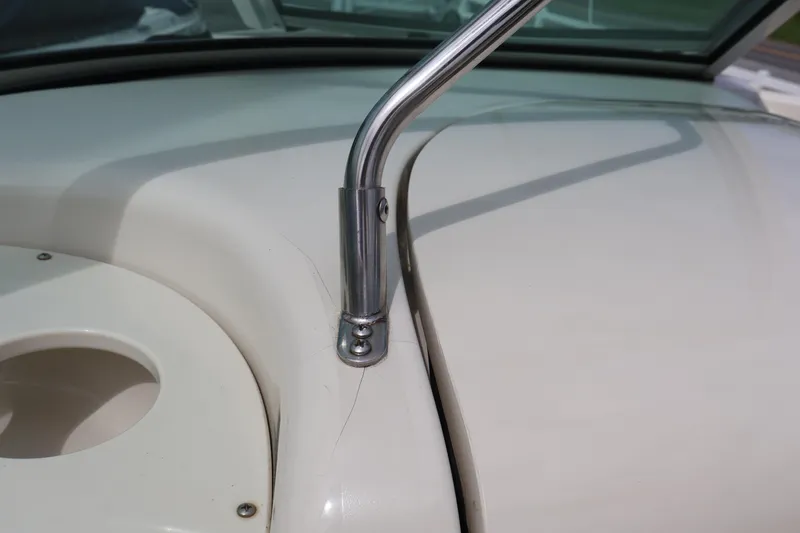 Slide: The Image of Close-up of a 2007 Sea Ray 220 Sundeck boat's windshield frame and deck detail. - 22