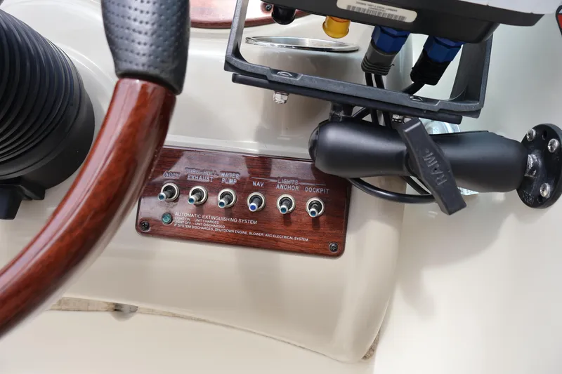 Slide: The Image of Control panel of a 2007 Sea Ray 220 Sundeck boat with switches and steering wheel. - 26