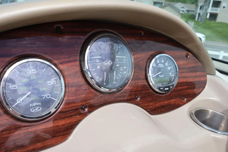 Slide: The Image of Dashboard of 2007 Sea Ray 220 Sundeck with wood finish and gauges. - 28