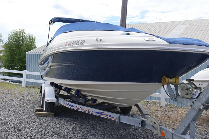 Slide: The Image of 2007 Sea Ray 220 Sundeck boat on trailer, covered and parked outdoors. - 3