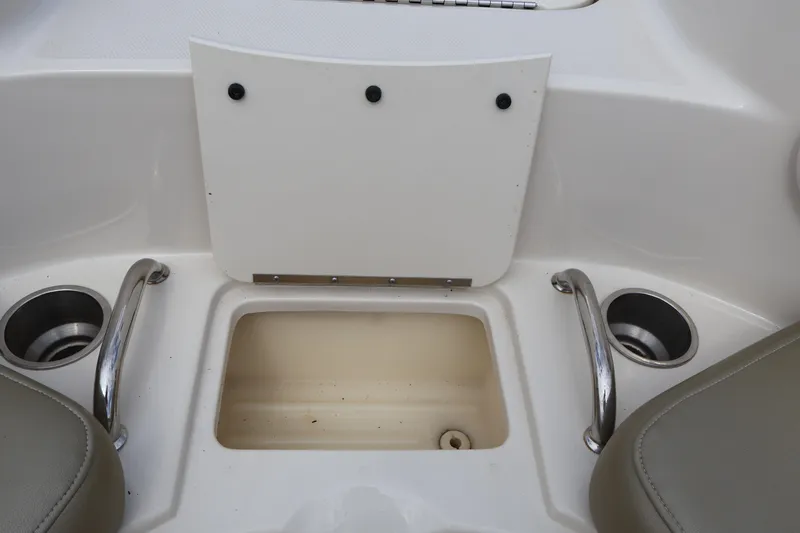 Slide: The Image of 2007 Sea Ray 220 Sundeck interior with storage compartment and cup holders. - 42