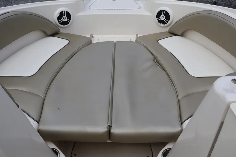 Slide: The Image of 2007 Sea Ray 220 Sundeck interior with cushioned seating and built-in speakers. - 46