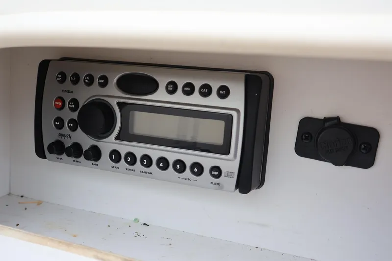 Slide: The Image of 2007 Sea Ray 220 Sundeck stereo system with control panel and auxiliary input. - 49