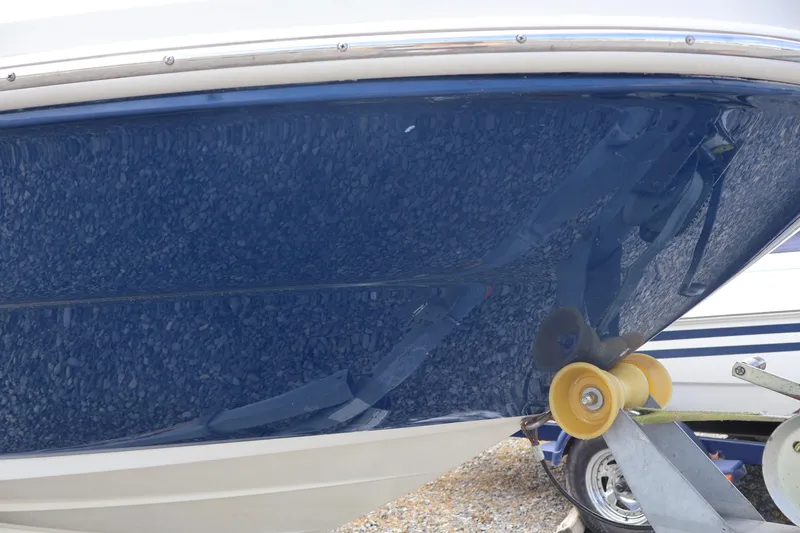 Slide: The Image of Close-up of a 2007 Sea Ray 220 Sundeck boat hull on a trailer. - 55