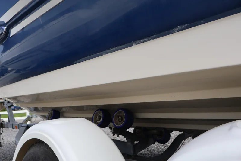 Slide: The Image of 2007 Sea Ray 220 Sundeck boat on trailer, close-up view of hull and wheels. - 61