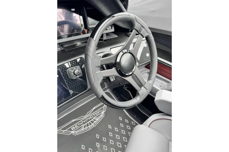 Slide: The Image of Steering wheel of 2026 Bennington 23 M Center Swingback boat, featuring modern design and controls. - 10
