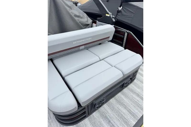 Slide: The Image of 2026 Bennington 23 M Center Swingback boat seating, featuring sleek gray upholstery. - 6