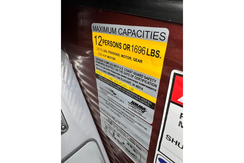 Slide: The Image of Capacity label on 2026 Bennington 23 M Center Swingback boat, 12 persons or 1696 lbs. - 7