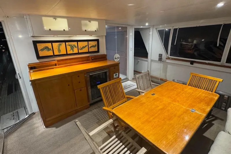 Slide: The Image of Luxurious interior of a 1974 Burger 67 Motor Yacht with wooden dining area. - 10