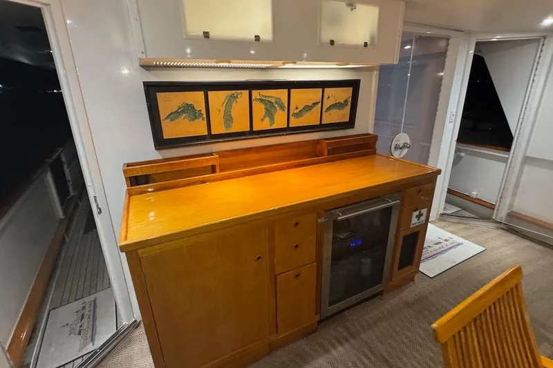 Slide: The Image of Interior of 1974 Burger 67 Motor Yacht with wooden cabinetry and nautical artwork. - 11