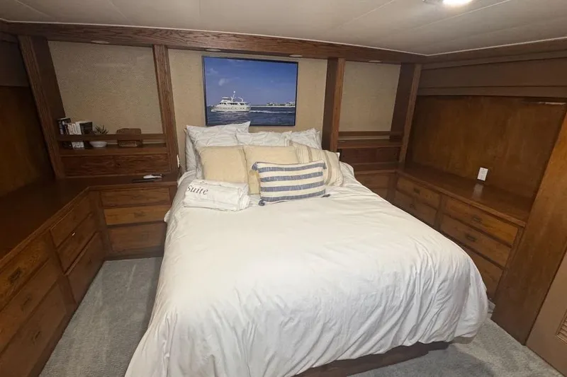 Slide: The Image of Cozy bedroom on a 1974 Burger 67 Motor Yacht with wooden cabinetry and nautical decor. - 12