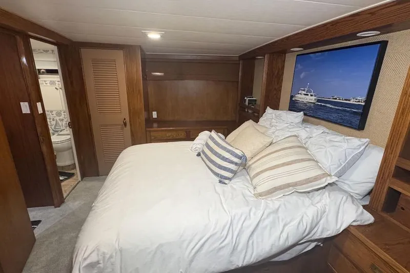 Slide: The Image of Cozy bedroom interior of 1974 Burger 67 Motor Yacht with nautical decor and wooden accents. - 13