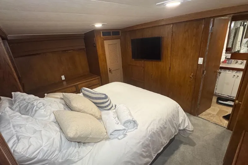 Slide: The Image of Luxurious bedroom interior of 1974 Burger 67 Motor Yacht with wood paneling and modern amenities. - 14