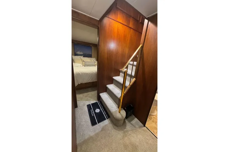 Slide: The Image of Interior of 1974 Burger 67 Motor Yacht with wooden stairs and cozy bedroom. - 17