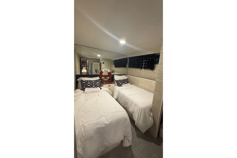Slide: The Image of Interior of 1974 Burger 67 Motor Yacht with twin beds and nautical decor. - 18