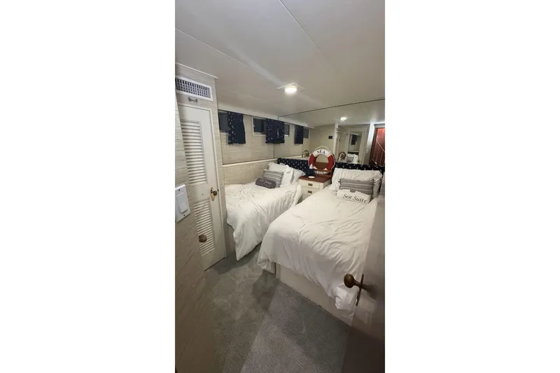 Slide: The Image of Interior of 1974 Burger 67 Motor Yacht with twin beds and nautical decor. - 19