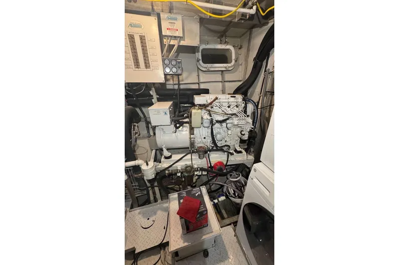 Slide: The Image of Engine room of a 1974 Burger 67 Motor Yacht, featuring machinery and control panels. - 24
