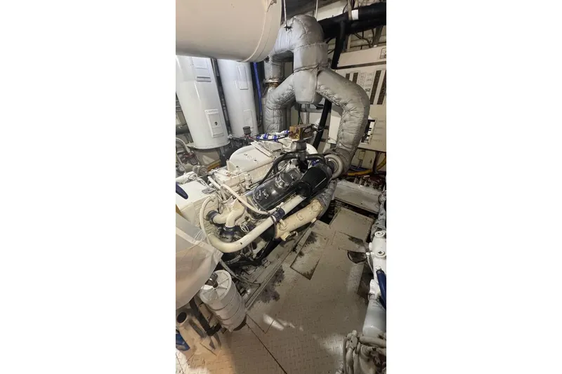 Slide: The Image of Engine room of a 1974 Burger 67 Motor Yacht, showcasing mechanical components. - 25
