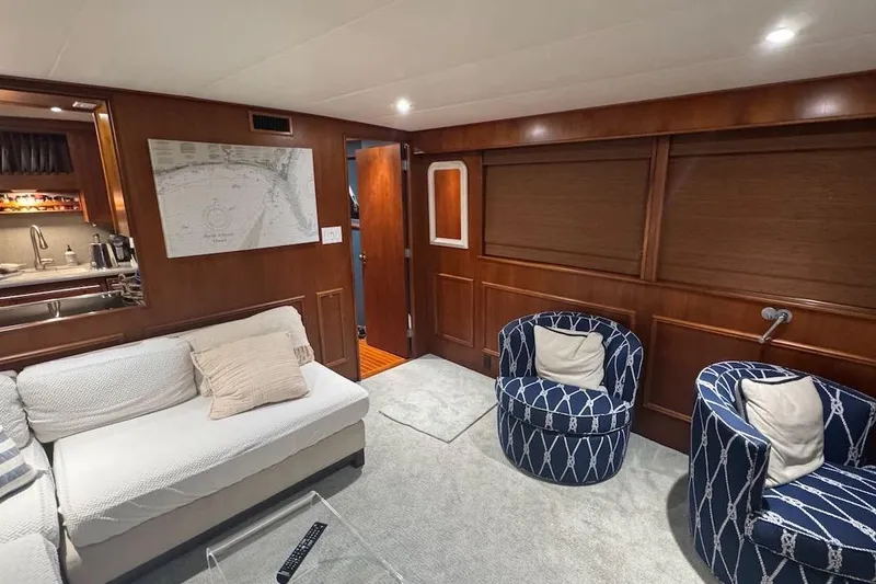 Slide: The Image of Luxurious interior of a 1974 Burger 67 Motor Yacht with elegant seating and wood paneling. - 4
